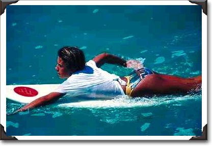 Surfer girl paddling, Hawaii