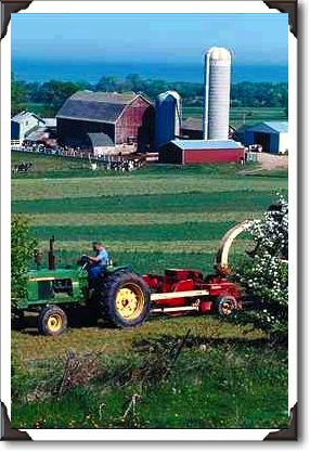Richard plows hay on his farm, Wisconsin